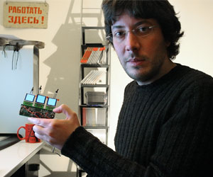 Artemy Lebedev, creator of the Optimus mini three keyboard, holding a prototype.