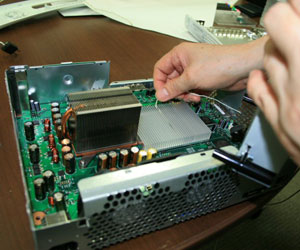 The major causes for overheating problems in the Xbox 360 were the inadequate heatsink and tiny fans.
