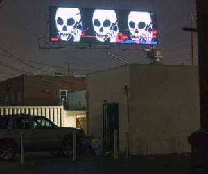 The artist's logo appeared on at least ten ClearChannel billboards and lead people to believe they had been hacked.